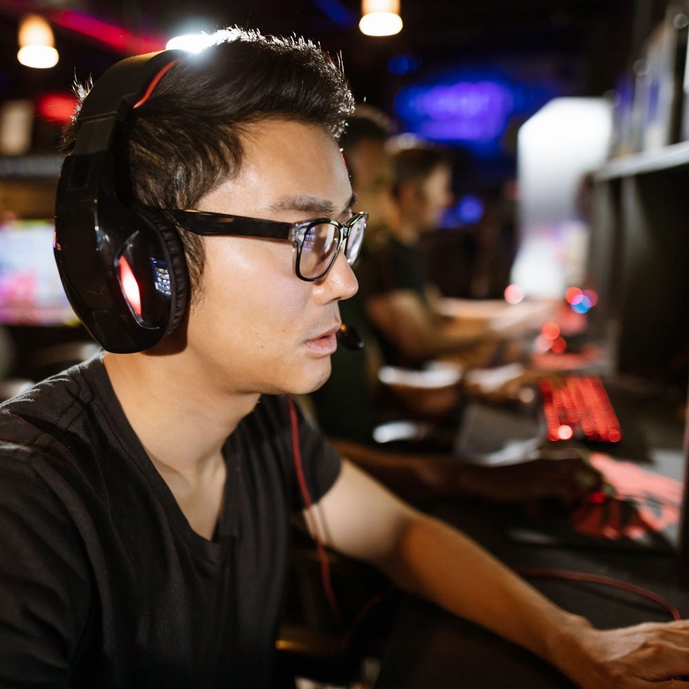 Two side-by-side monitors on a shared bench set up for co-op play